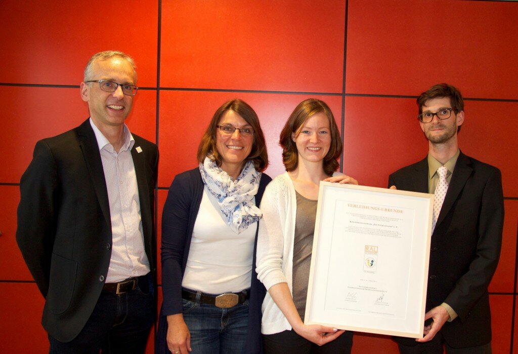 Leiter der Bildungsabteilung Dr. Thilo Esser, Regina Eckert de Villanueva und Carolin Krummacker verantwortlich für den Freiwilligendienst im Kindermissionswerk "Die Sternsinger" (v.l.) nehmen vom Geschäftsführer der Gütegemeinschaft Markus Linsler die Verleihungs-Urkunde entgegen. Foto: Anna Preisner/Kindermissionswerk.